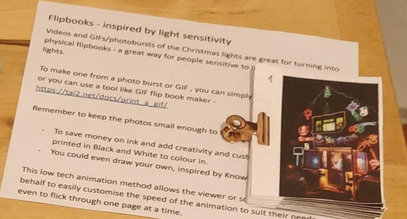 rough paper flipbook, bound with a mini bulldog clip, on a table.